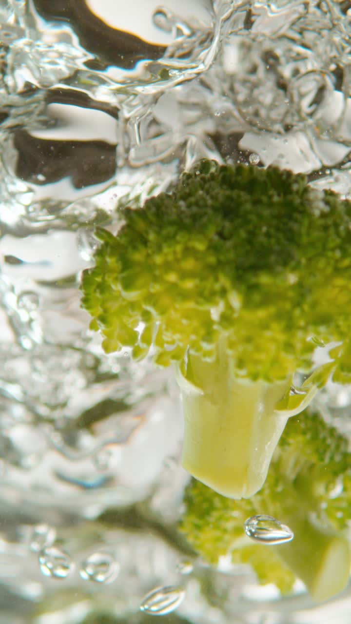 Broccoli submerged in water with bubbles