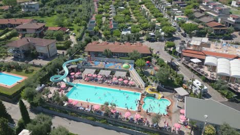 Wide-angle-drone-shot-swimming-pool-at-luxury-holiday-resort-in-sun