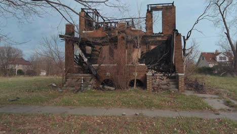 drone view of dilapidated house in a detroit neighborhood