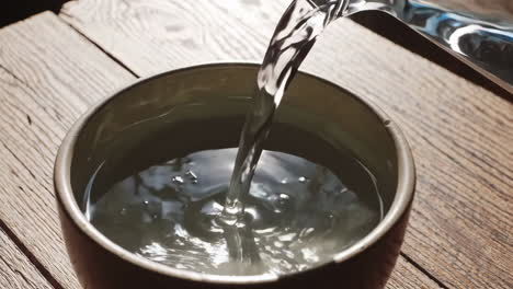 pouring water into a bowl