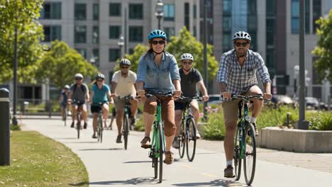 group of people cycling on a sunny urban path