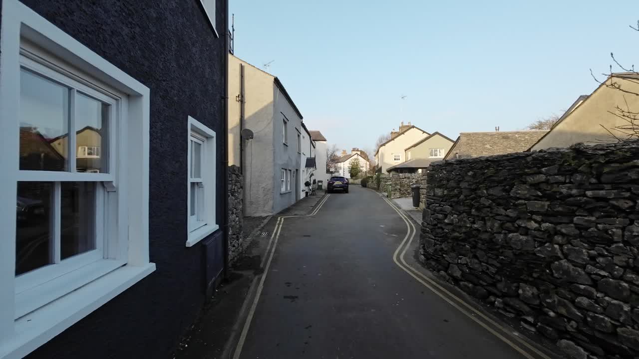 Editorial footage of the Cumbrian Village of Cartmel in the English Lake District. Showing traffic and tourists walking and shopping