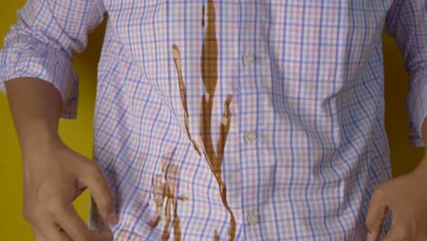 man with coffee stain on his shirt