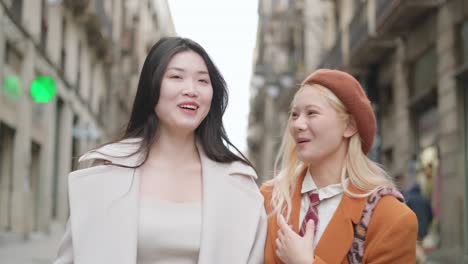 two stylish friends walking on the street