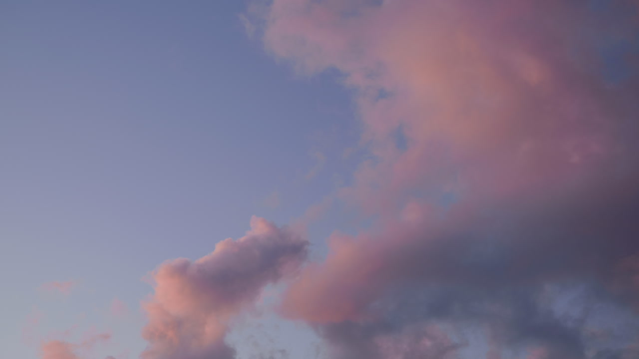 Clouds moving slowly with the wind in a sunset