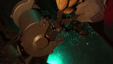 Slow-motion-of-tool-sharpened-on-bench-grinder