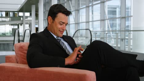 Businessman-using-mobile-phone-on-sofa-4k