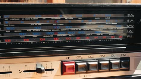 old retro am fm radio with tubes, hand changing stations , bulb vintage music player.