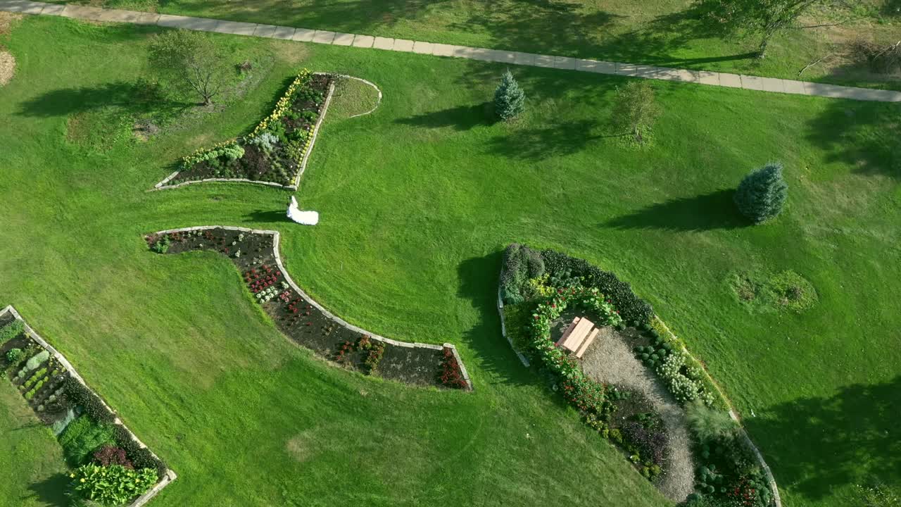 Wedding couple in a beautiful garden drone shot