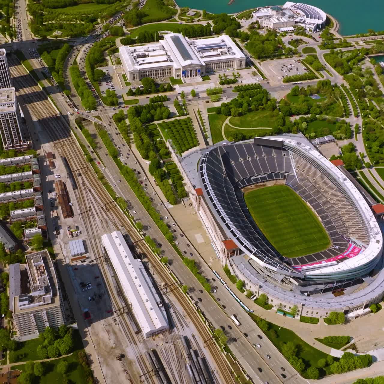 Breath-taking view of a large green downtown Chicago territory. Soldier Field Stadium, yacht club, park and lively avenue road from aerial perspective