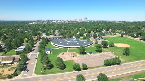 aerial drone flyover of elementary school in a suburb of denver, colorado surrounded by houses in middle class neighborhood