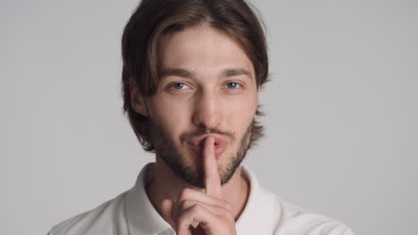 caucasian man in front of camera on gray background.