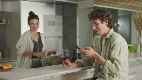 couple relaxing and preparing food in a modern kitchen