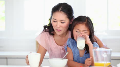 Mother-and-daughter-drinking-as-they-sit-together