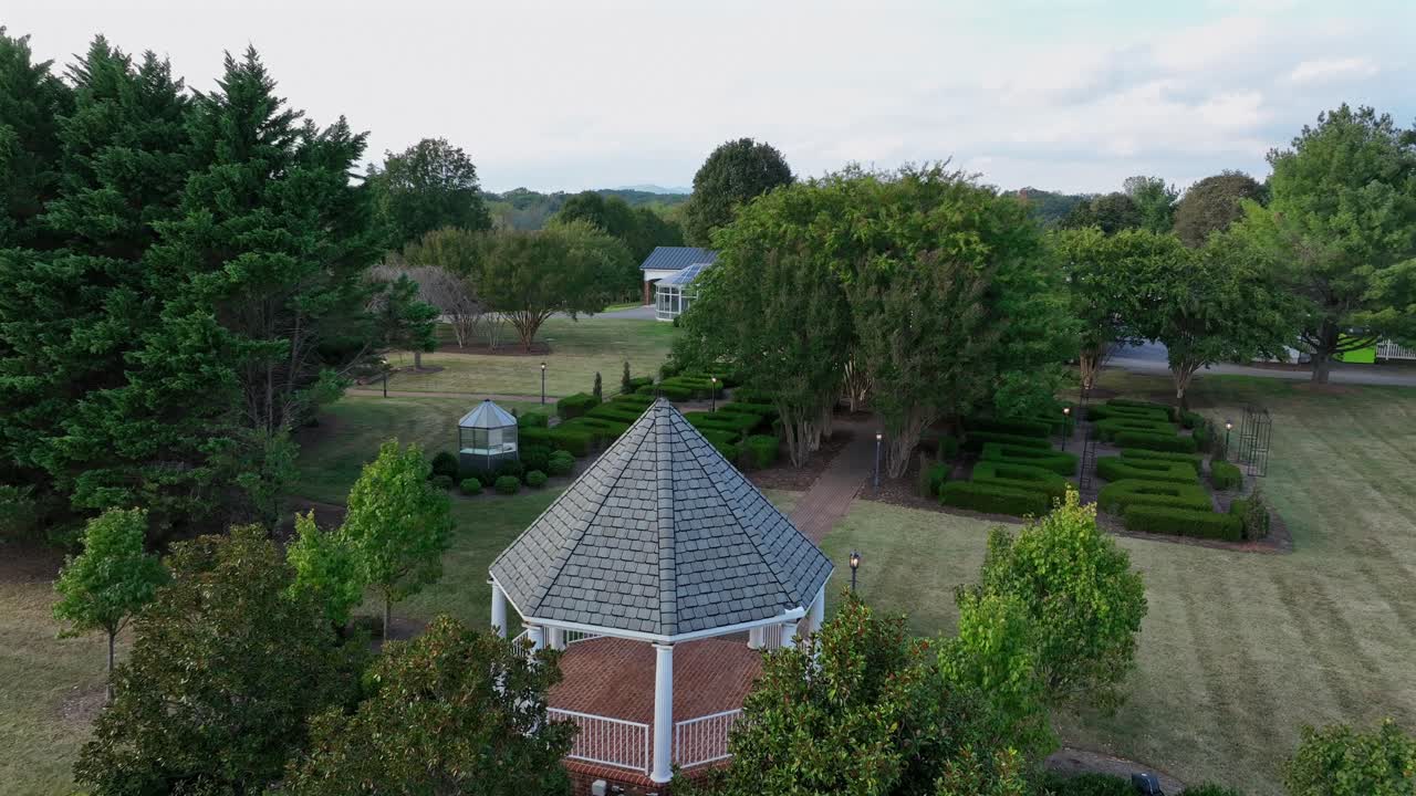 Pavilion in well-kept garden of luxury villa. Aerial view. Green hedge and grass in Virginia. West manor estate in Lynchburg, Va. cloudy summer day in USA