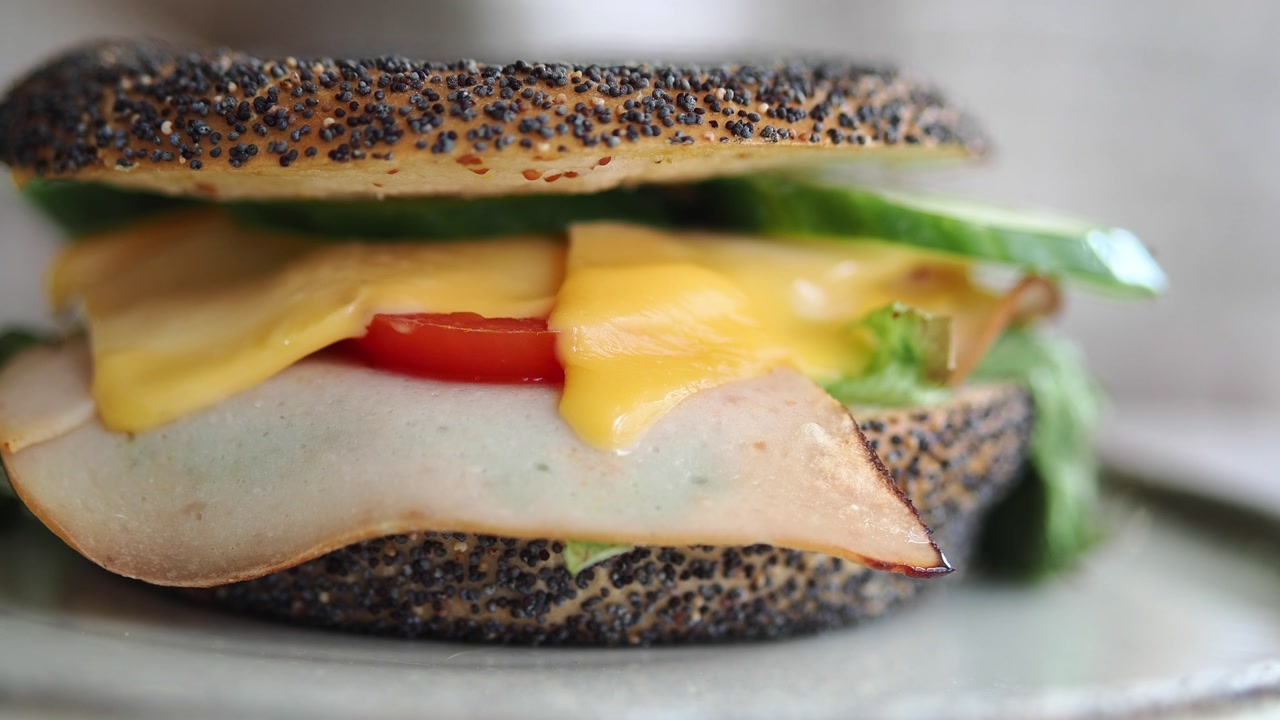 Close-up of a Fresh Poppy Seed Bagel Sandwich with Turkey and Vegetables