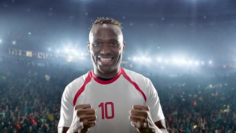 happy soccer player on a football stadium