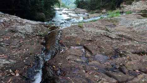 waterfall cascading over rocks in springbrook, qld