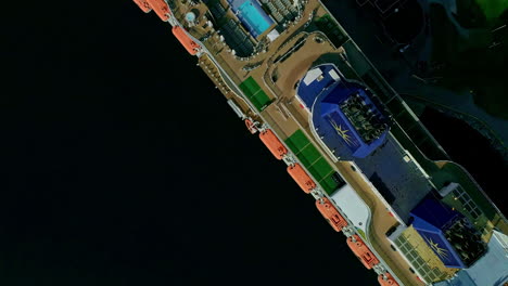 Aerial-topdown-view-of-docked-cruise-ship-top-deck-flyover