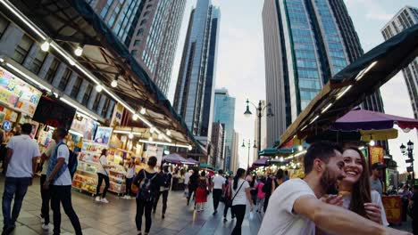 couple enjoying street food in a city market