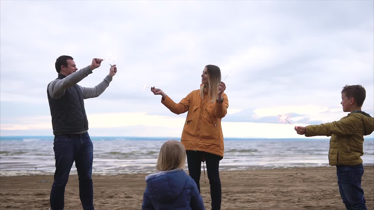 Family Celebrating at the Beach with Sparklers