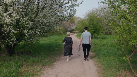 mother and son walking through a spring garden