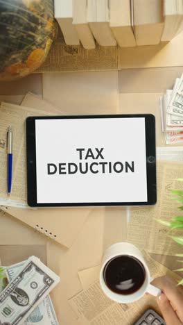 vertical video of tax deduction displaying on finance tablet screen