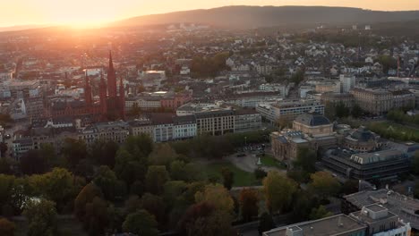 drone circle shot around city center of wiesbaden in germany at best light showing the marktkirche and the kur area with its parc