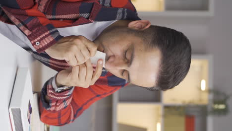 Vertical-video-of-The-afflicted-man.-The-man-is-looking-at-the-photo-and-kissing-it.