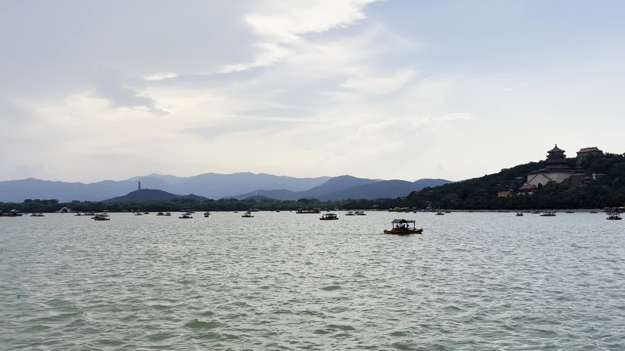 Boats gently drift across the tranquil man-made lake at the Summer Palace in Beijing