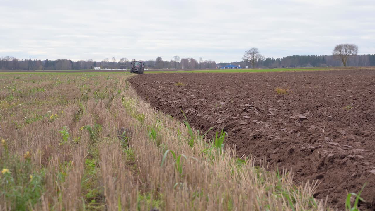 Static low POV shot of farm tractor approaching