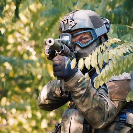 un jugador de airsoft se esconde en una espesura de árboles 1