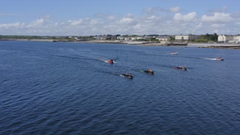 Aerial-orbit-around-currach-boats-racing-through-atlantic-ocean