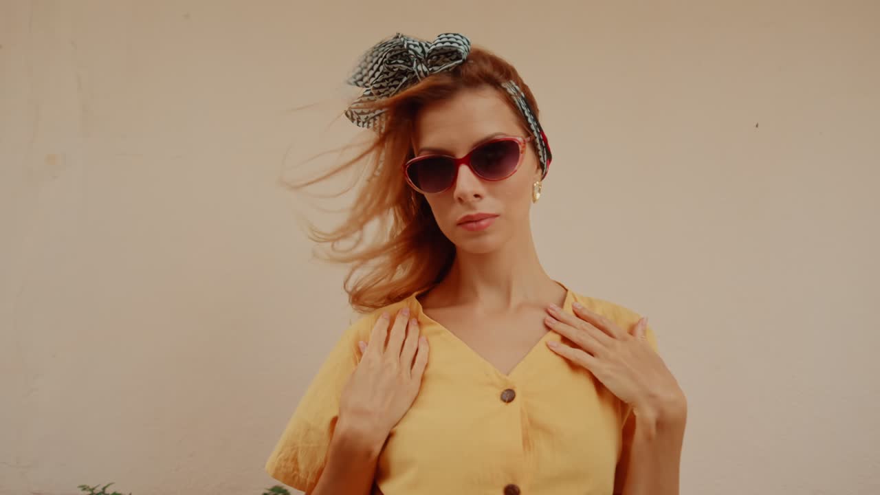 Stylish Woman in Sunglasses with Wind-Swept Hair