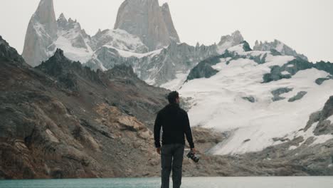 View-Behind-Man-Holding-Camera-While-Hiking-In-Mount-Fitzroy