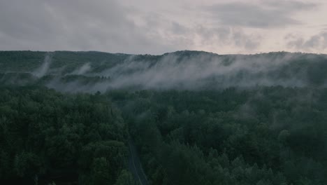 drone hovering looking at beautiful foggy mountain top landscape-3