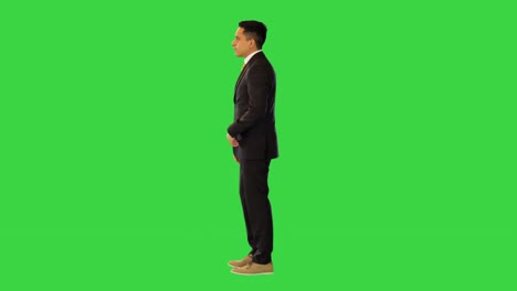 annoyed businessman tired of colleague or business partner being late look at wrist watch and leave on a green screen, chroma key