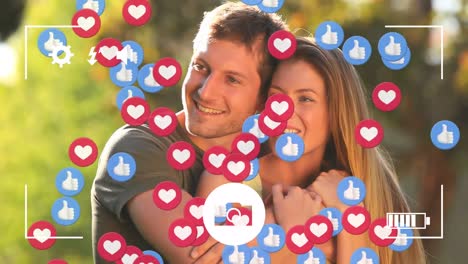 Animation-of-social-media-icons-and-play-screen-over-hugging-caucasian-couple