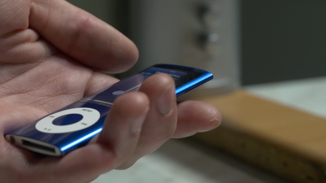 Person Holding a Vintage Blue iPod