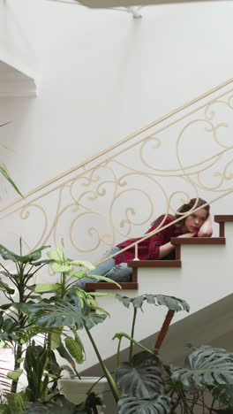 woman expresses melancholy lying on staircase. lady with mental health problems has seizure at home. broken woman needs psychological treatment