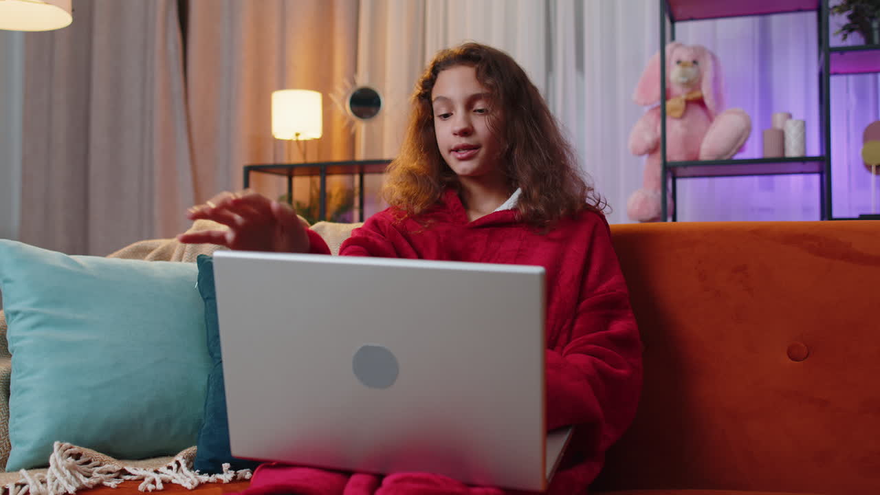 Young girl freelancer sitting on couch closing laptop pc after finishing education in room at home