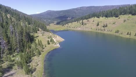 revealing a vast canyon, the drone flies towards the water