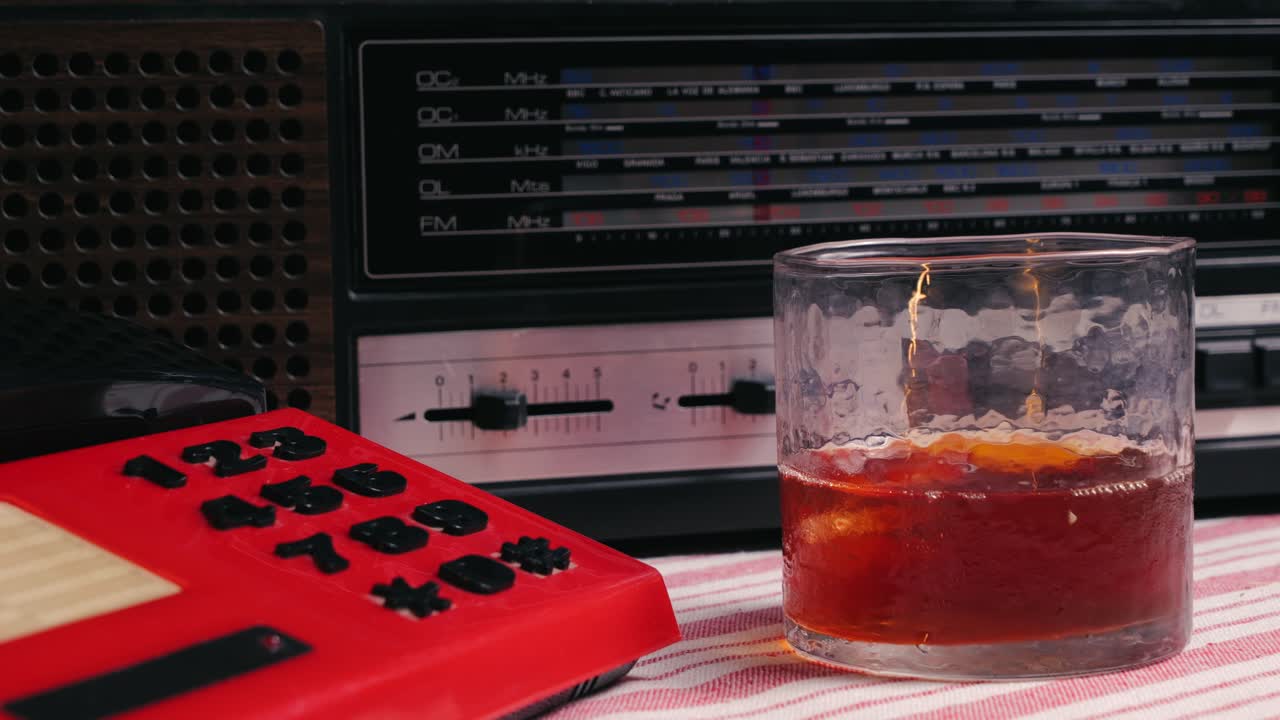 Retro vintage red phone, telephone is displayed on a wooden desk, adding a nostalgic touch. Man answer for call on button 90 phone.