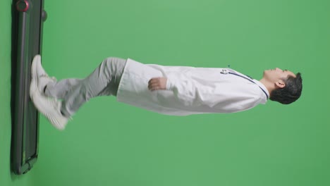 full body of side view asian male doctor with stethoscope looking around and walking on green screen background in the hospital