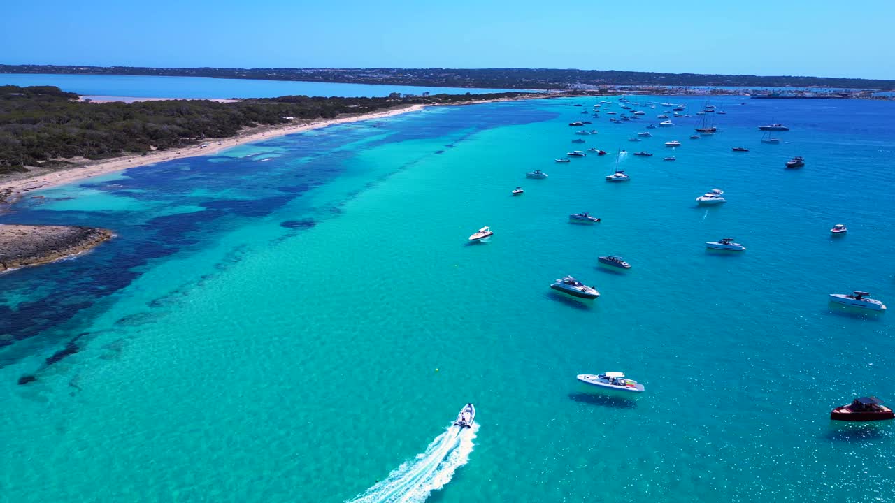 Scenic aerial view of rocky Island Formentera's turquoise azur waters and sandy beaches. Stunning aerial view flight rotation to left drone