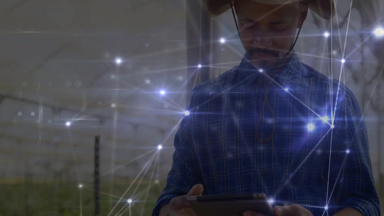 Vertical video: Field tech tapping tablet, causing nodes glowing while monitoring greenhouse crops