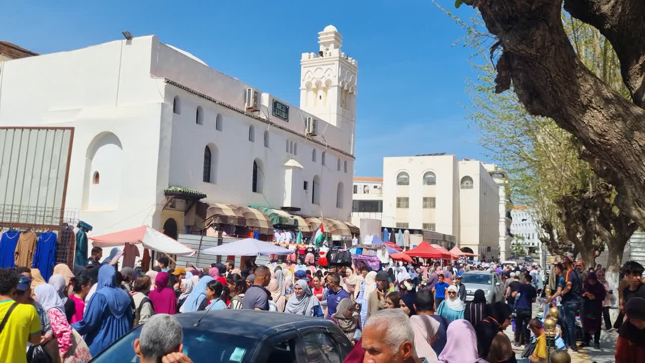 Busy Street Market in Moroccan City with Mosque