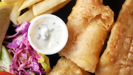 fish and chips plate with fries and coleslaw