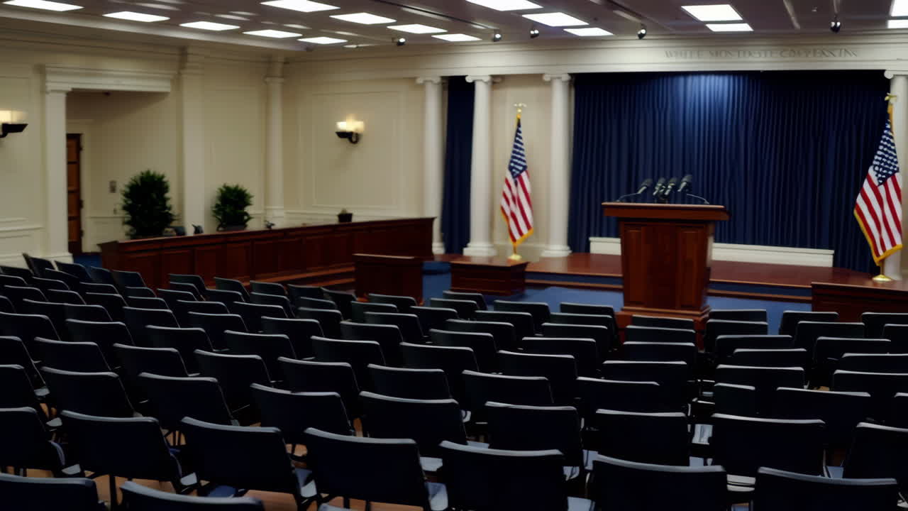 An empty government press briefing room with a podium and microphones