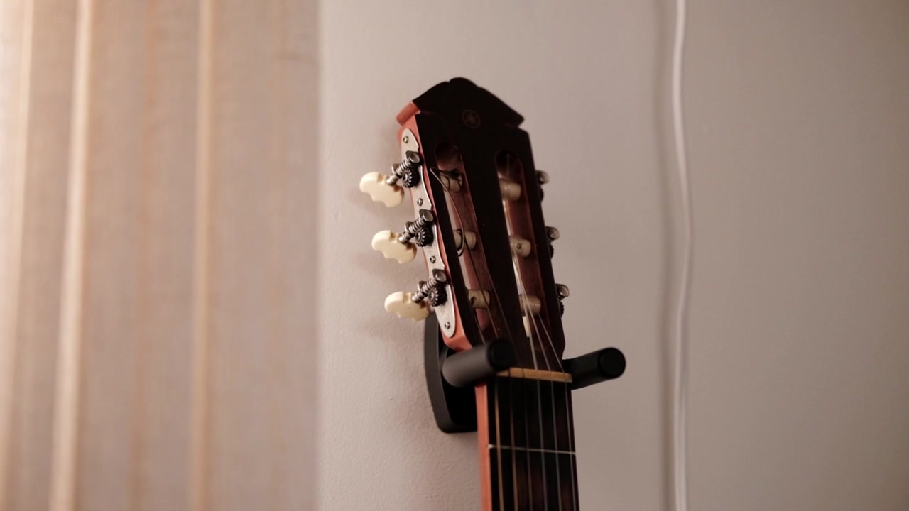 Head of an acoustic guitar hanging on a wall fitting